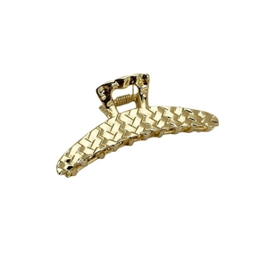 Golden metal hair claw clip with woven texture design shown on a clean white background