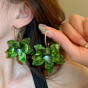 French retro resin flower hoop earrings in dark green with golden hooks worn by model