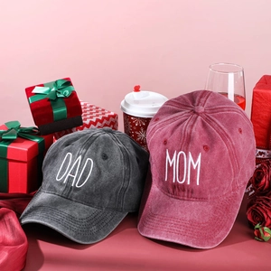 Vintage washed cotton baseball caps with DAD and MOM embroidery in a festive gift setting