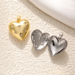 Close-up of heart-shaped 18K gold and silver lockets with star patterns and small zircons