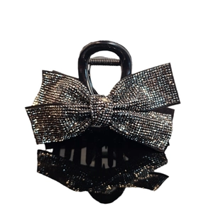 Elegant medium black shark hair claw clip with a sparkling rhinestone bowtie design