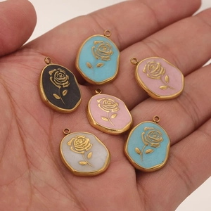 Detailed close-up of oval stainless steel rose pendants with colorful enamel inlay finish