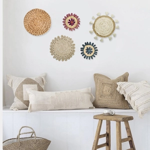 Detail of woven wall decor and boho pillows made of seagrass and cotton linen textures