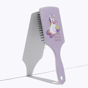 Detail of purple square air cushion brush featuring a cute unicorn and stars pattern