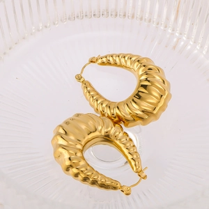 Classic 18K gold plated croissant twist hoop earrings displayed in a glass bowl