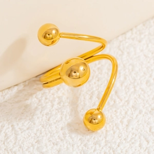 Detail view of 18k gold plated stainless steel spiral ring with three spherical ornaments