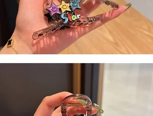 Detail view of amber translucent hair claw clip with colorful smiley star decorations