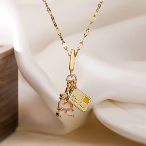 Gold-plated necklace with bear pendant and Have a nice trip engraved rectangle tag