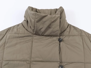 Detail view of quilted olive green cotton jacket showing stand collar and round buttons