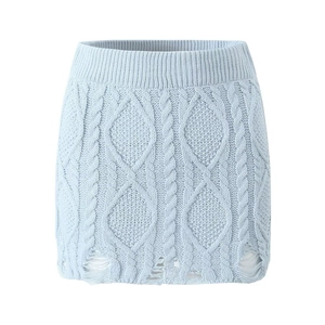 Detail of light blue cable knit mini skirt featuring distressed fringe hem design
