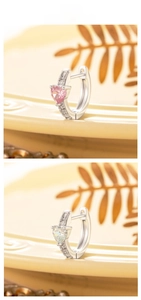 Detail of heart-shaped zircon earrings in pink and white with micropave setting
