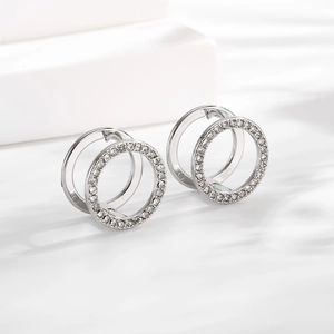 Macro detail of silver geometric double hoop earrings with pavé cubic zirconia inlay