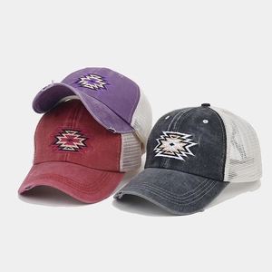 Detail of distressed ponytail baseball cap with vintage embroidery and breathable mesh