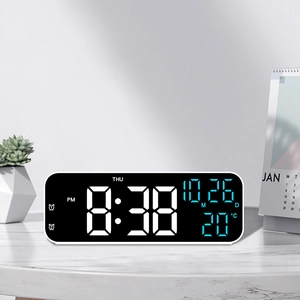 Modern 9-inch black LED digital clock showing time, date, and temperature on marble desk