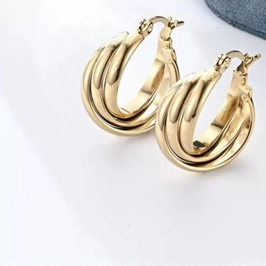 Classic golden triple-hoop earrings featuring a layered twist design on a white background
