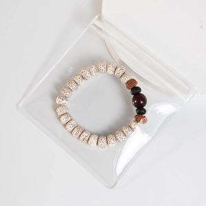 Thick transparent PVC self-sealing jewelry bag showing a beaded bracelet inside