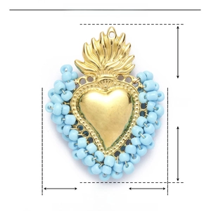 Macro detail of heart pendant with blue beads and gold stainless steel material specs