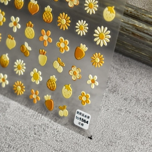 Detail of 5D embossed nail art stickers with cute fruit and floral patterns in beige tone
