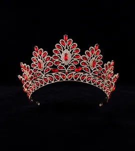 Detail of vintage gold bridal crown featuring teardrop red gems and sparkling crystals