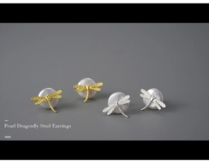 Detail of silver and gold pearl dragonfly stud earrings with textured wing design