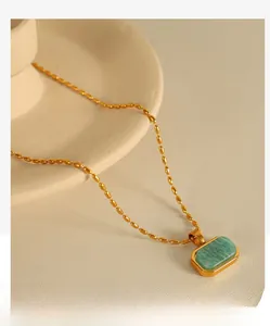 Detailed view of amazonite pendant necklace on elegant ceramic tray with gold bead chain