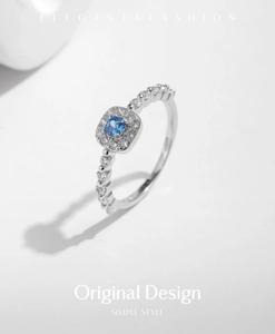 Detailed close-up of a s925 silver ring featuring a blue square zircon with side stones