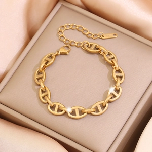 Elegant gold stainless steel coffee bean link bracelet displayed on beige leather box