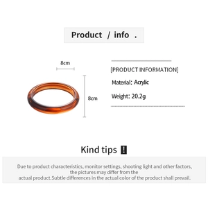 Macro detail of amber acrylic bangle with 20.2g weight and 8cm diameter specs