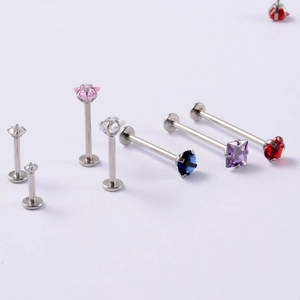 Macro shot of stainless steel labret studs with multi-color heart-shaped cubic zirconia stones