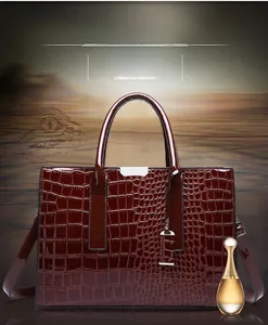 Close-up of wine red crocodile pattern embossed leather texture on women tote bag