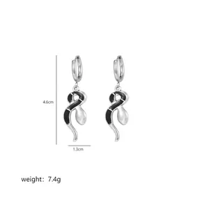 Detailed view of silver snake earrings showing 4.6cm height and 1.3cm width dimensions