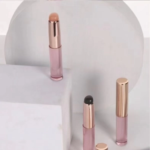 Rose gold silicone lip brushes on marble props for lipstick and concealer blending