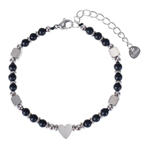 Detail of beaded bracelet featuring matte black stones and a silver heart charm