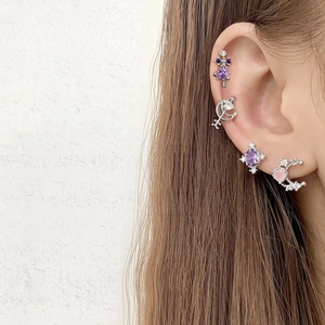 Detailed view of layered ear set with purple zircon, moon, and pink heart studs