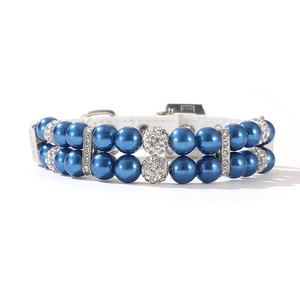 Detailed macro view of double-layer faux pearls and rhinestone spacers on pet collar