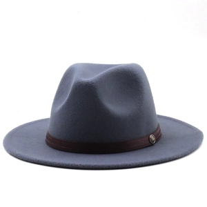 Detail of blue-gray wool fedora hat featuring a brown woven band and vintage metal badge