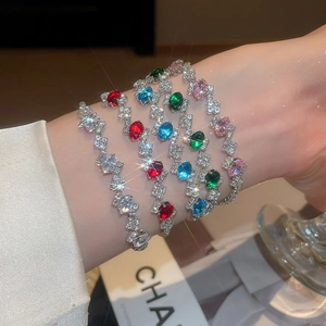 Detail view of multi-color oval zircon stones on a silver-plated luxury tennis bracelet