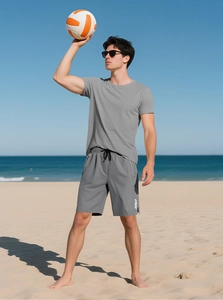 Detail of men's grey fitness set showing short-sleeve shirt and drawstring sports shorts