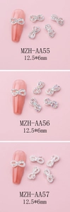 Detailed close-up of alloy bowknot nail charms with rhinestones and pearls for DIY art
