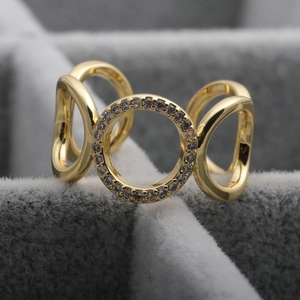 Macro shot of 18K gold ring with micro-paved zircon stones and intertwined circles