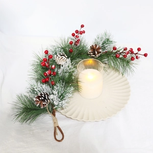 Detail of Christmas garland with pine needles, red berries and natural pinecones