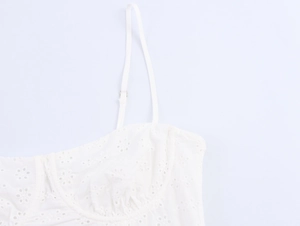 Detail of white eyelet embroidery corset top with adjustable spaghetti straps