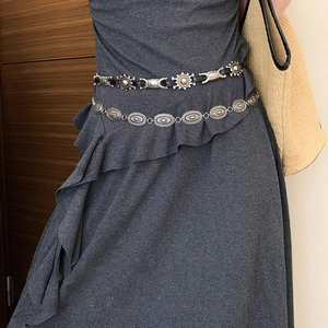 Vintage silver butterfly chain belt with geometric oval discs worn on a grey dress