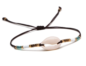Detail of adjustable bohemian bracelet with cowrie shell, seed beads, and woven wax cord