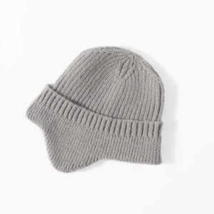 Detailed close-up of grey knitted earflap beanie showing premium wool texture and design