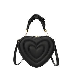Black heart-shaped handbag with 3D layered quilting and elegant gold zipper hardware