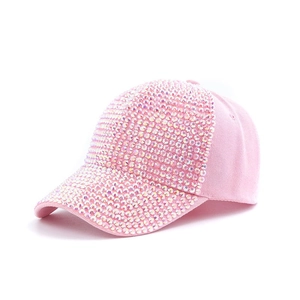 Close-up of pink cotton baseball cap with glittering rhinestones and adjustable strap