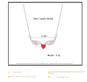 Detailed view of heart necklace with red zircon wings, showing size 3.2cm and 45cm chain length