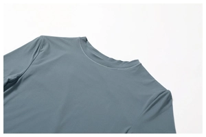 Close-up of crew neckline with reinforced stitching on gray-blue quick-dry athletic tee