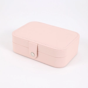 Pink faux leather jewelry box featuring a secure snap button closure and smooth edges
